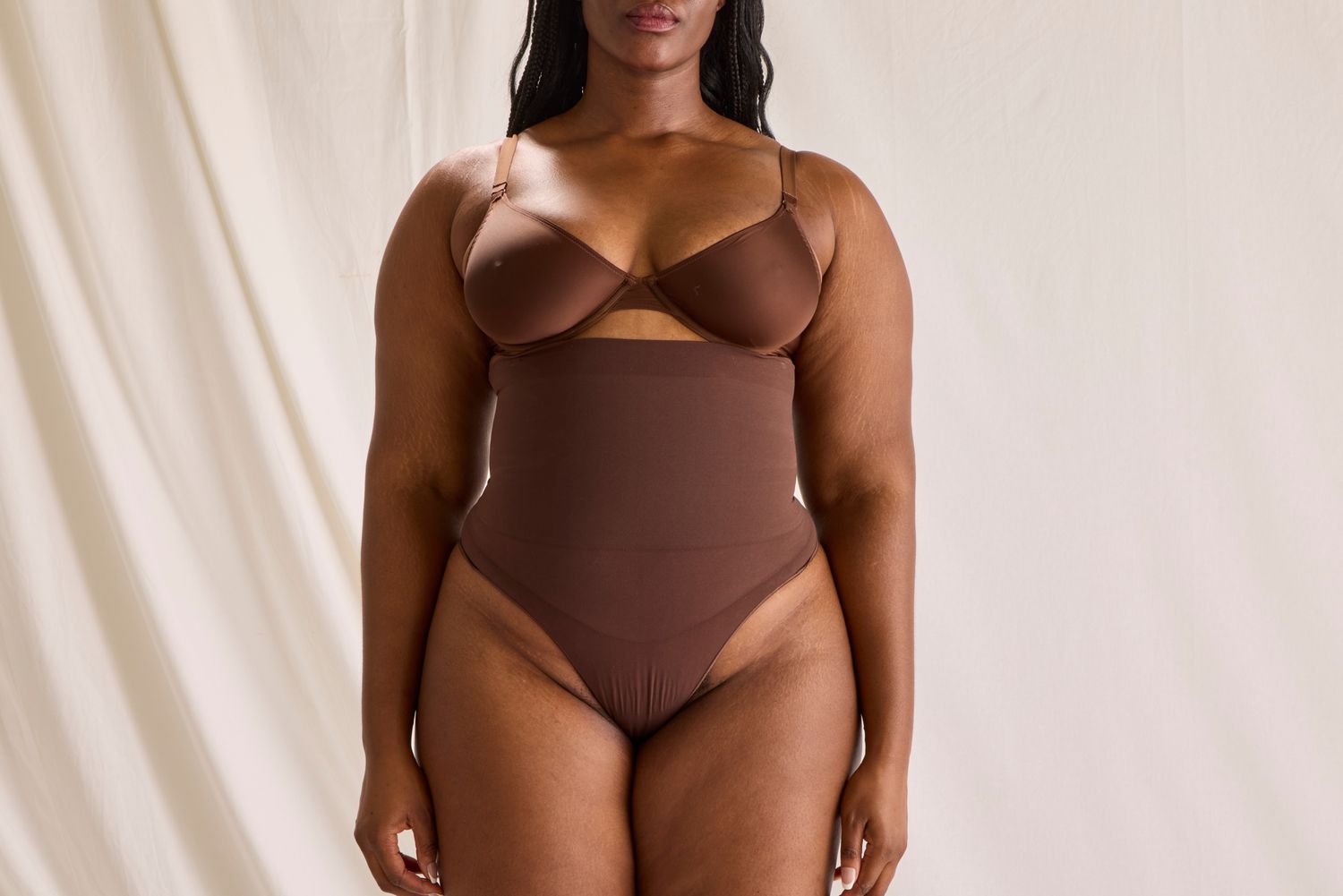 The front view of a woman wearing the SKIMS Core Control Thong