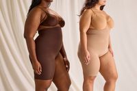 A side view of two people wearing the Skims Solution Short Left Leg Exposed in different colors