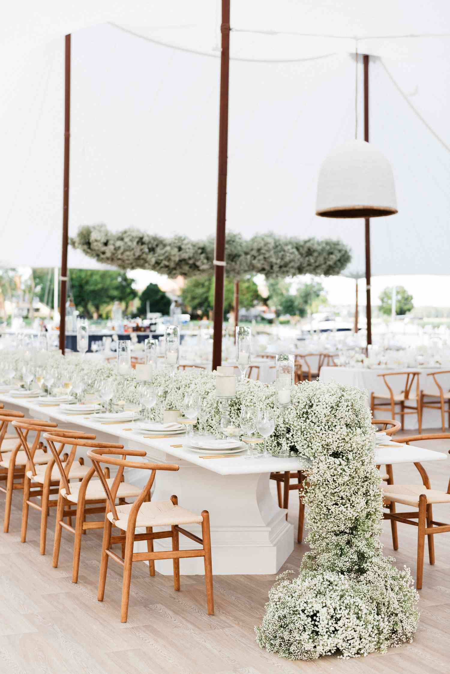 Tented Wedding Reception With Long Rectangular Tables Topped With Lush Garlands of Baby's Breath