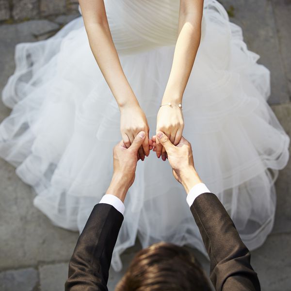 Bride and groom holding hands at the altar during wedding ceremony