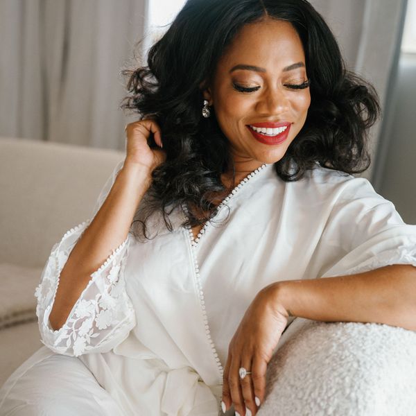 a bride posing in a white robe