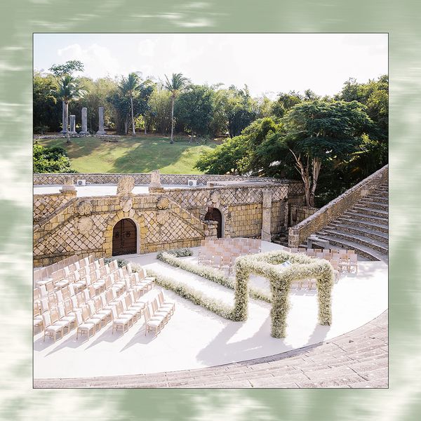 baby's breath ceremony arch in colosseum with green banner