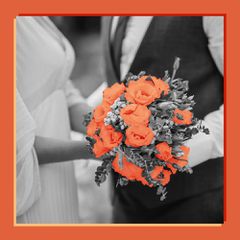 Black and White Image of Bride in Wedding Dress and Groom in Suit Holding Flower Bouquet With Pops of Verona Sunset Color