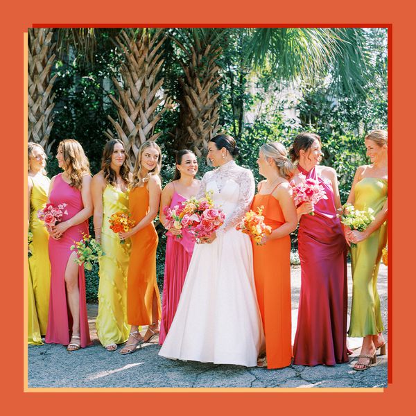 Bride in Long Sleeve Wedding Dress Posing With Bridesmaids in Bright Verona Sunset, Pink, and Yellow Dresses