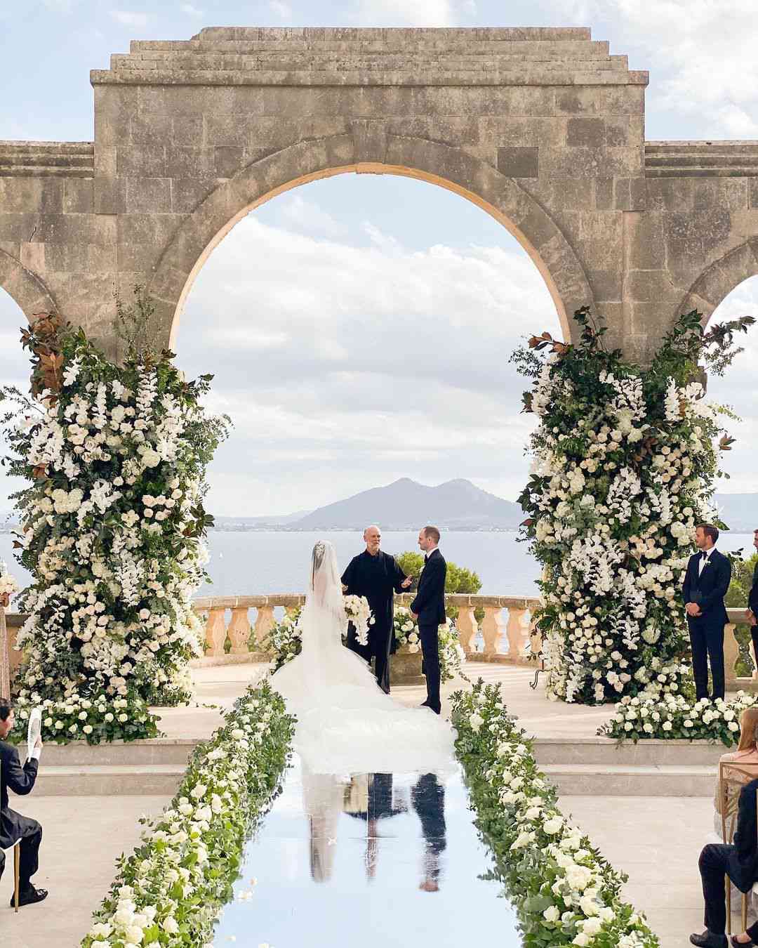 la fortalenza wedding venue with stone archway and ceremony florals on either side