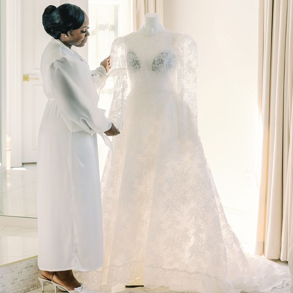a bride admiring her wedding dress