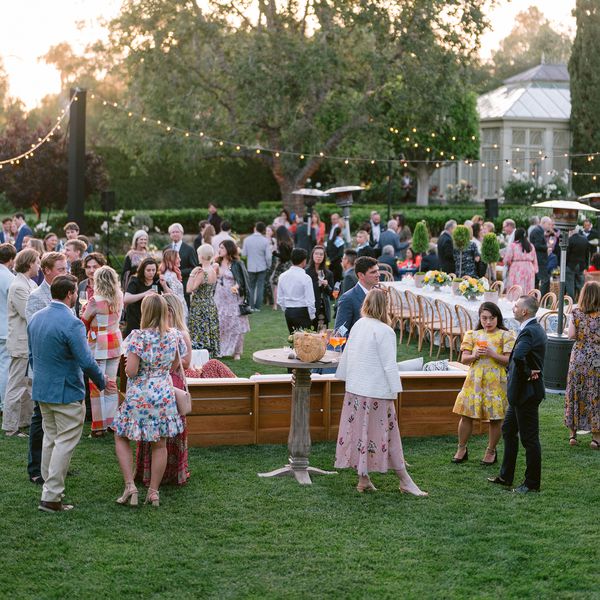 wide shot of wedding guests standing at an outdoor reception
