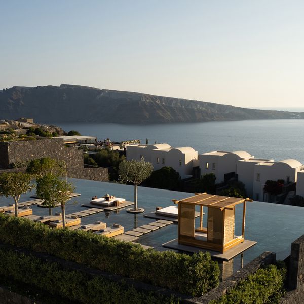 Resort Pool in Greece Overlooking Buildings and Ocean