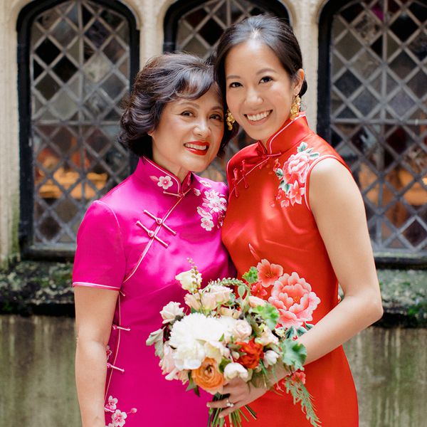 mother of the bride and bride holding bouquet