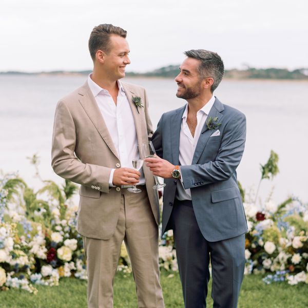 Two Grooms Celebrating After Their Wedding By Clinking Champagne Flutes