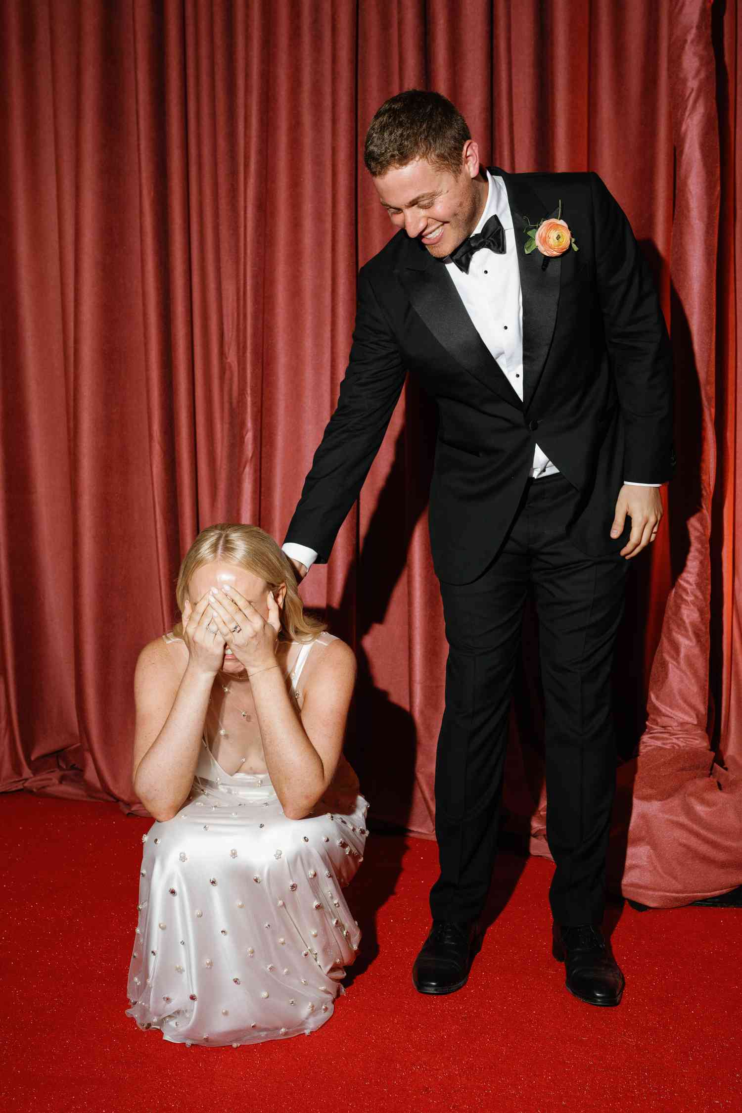 Bride Covers Her Eyes, PreparingHerself to Be Surprised, as Her and Her Groom Walk Into Their Reception