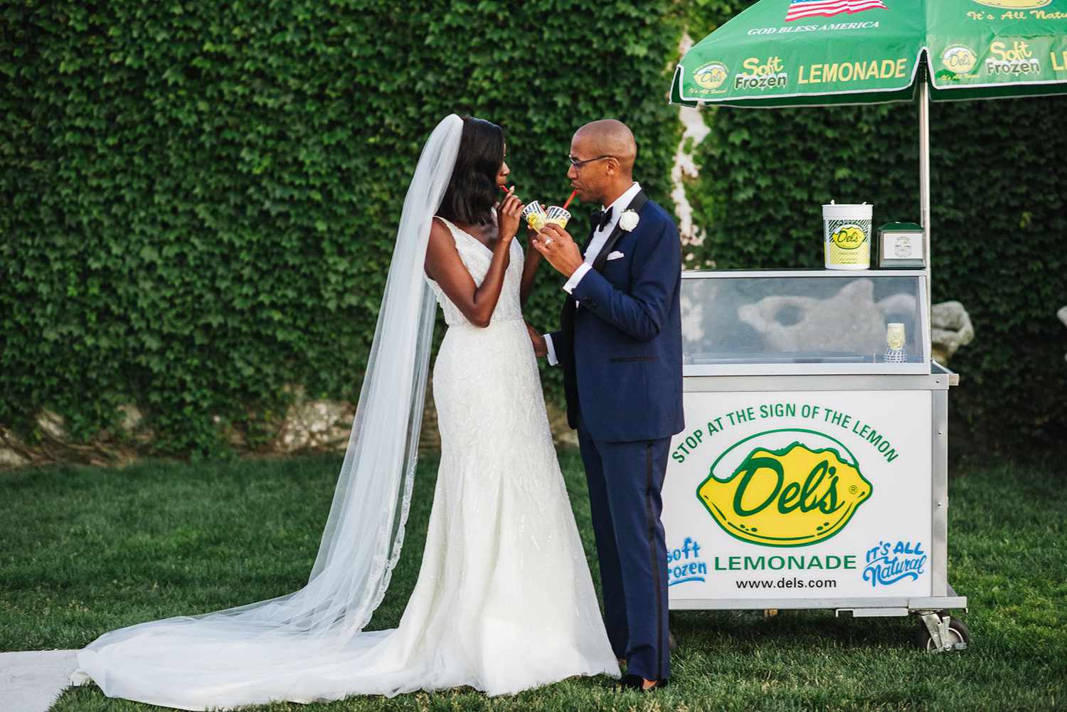 Couple standing by wedding lemonade stand