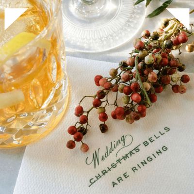 Christmas-themed wedding napkin, berry decor, and drink
