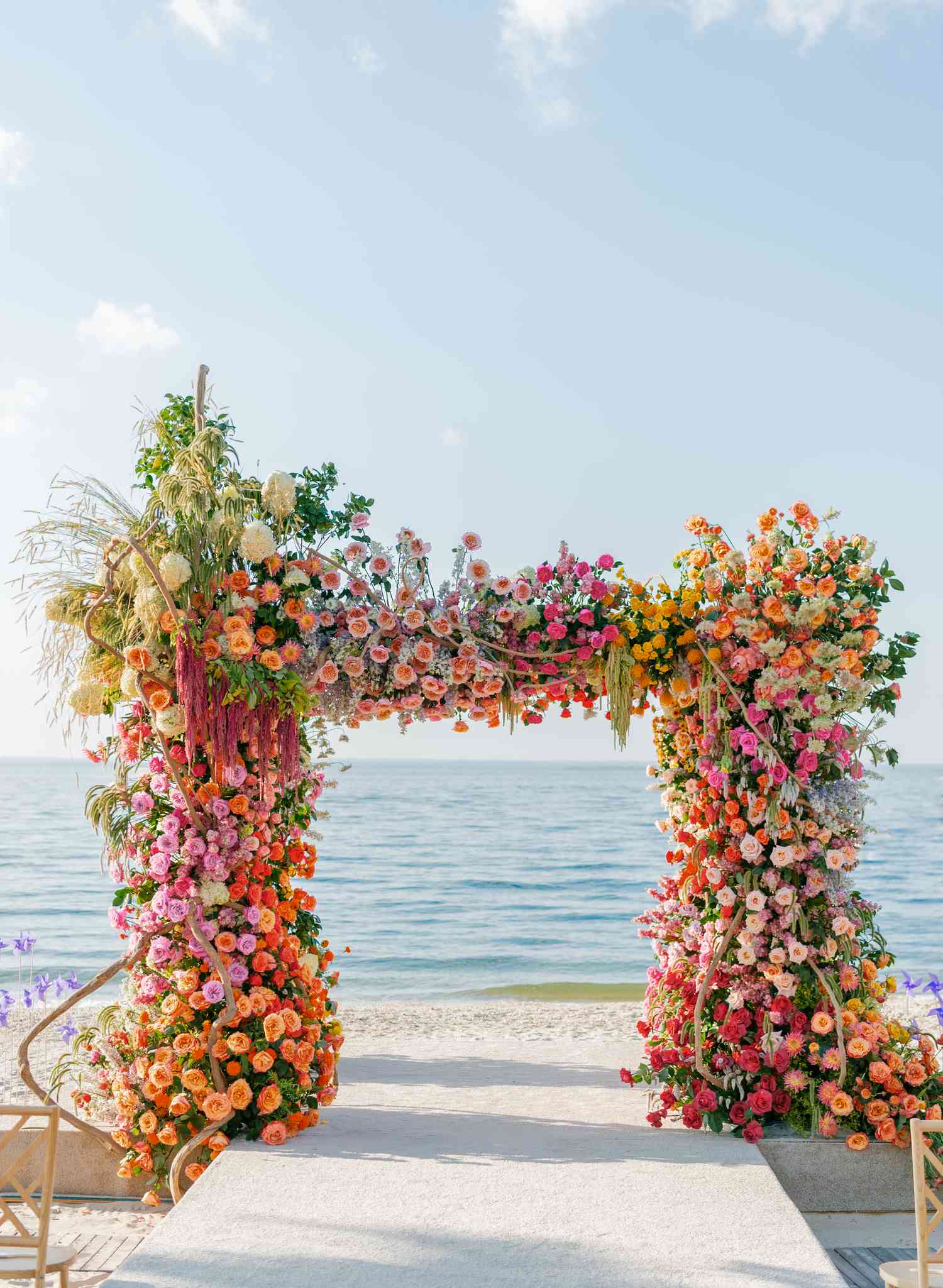 Colorful Floral Arch on the Beach in Front of the Ocean