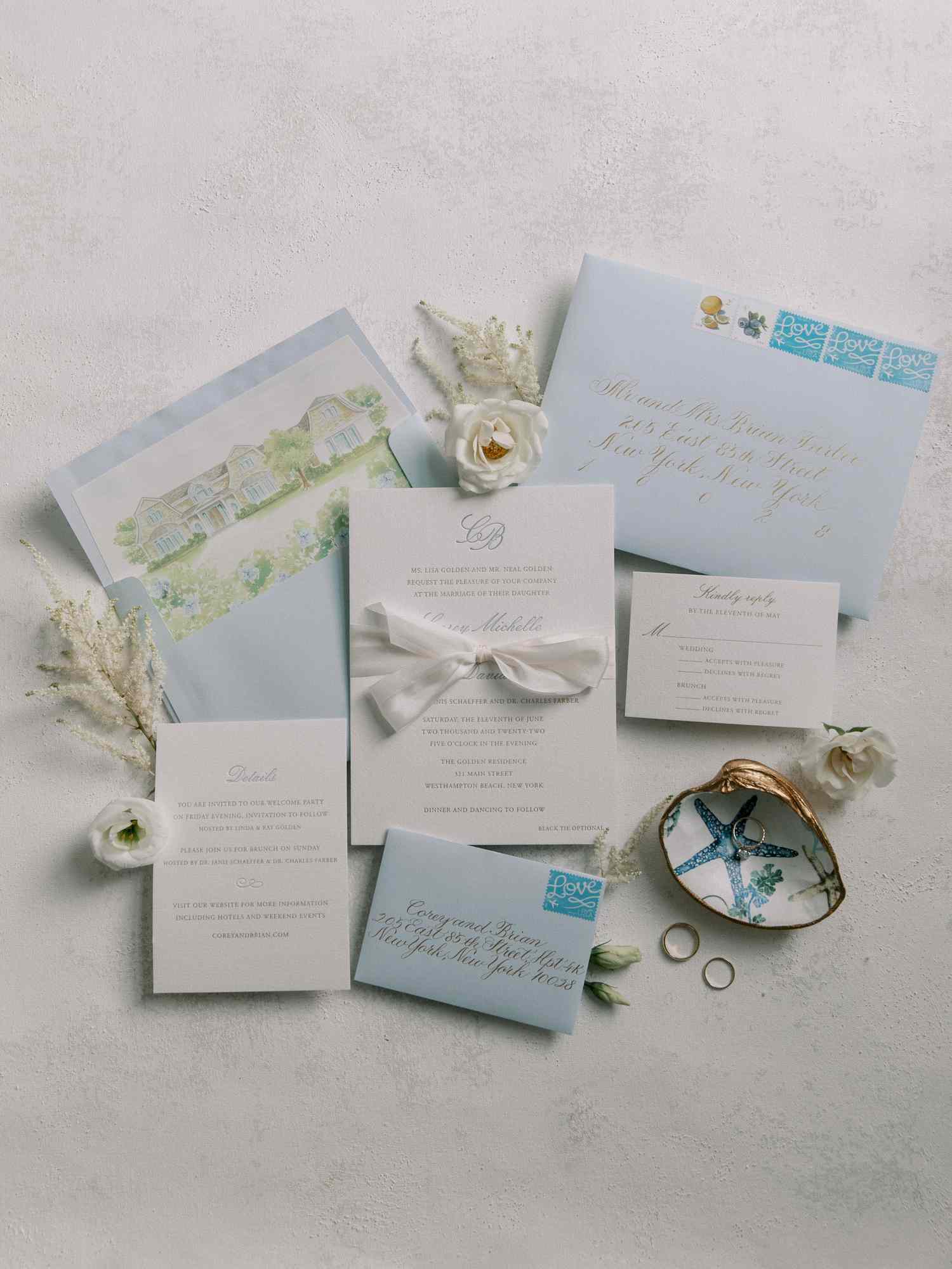 Elegant blue-and-white stationery suite with illustrated envelope liner of a beach house