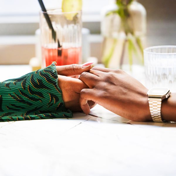Couple Holding Hands Across Restaurant Table