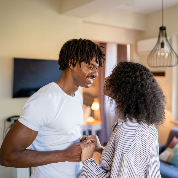 Couple Holds Hands While Looking at Each Other, Experiencing Sexual Tension