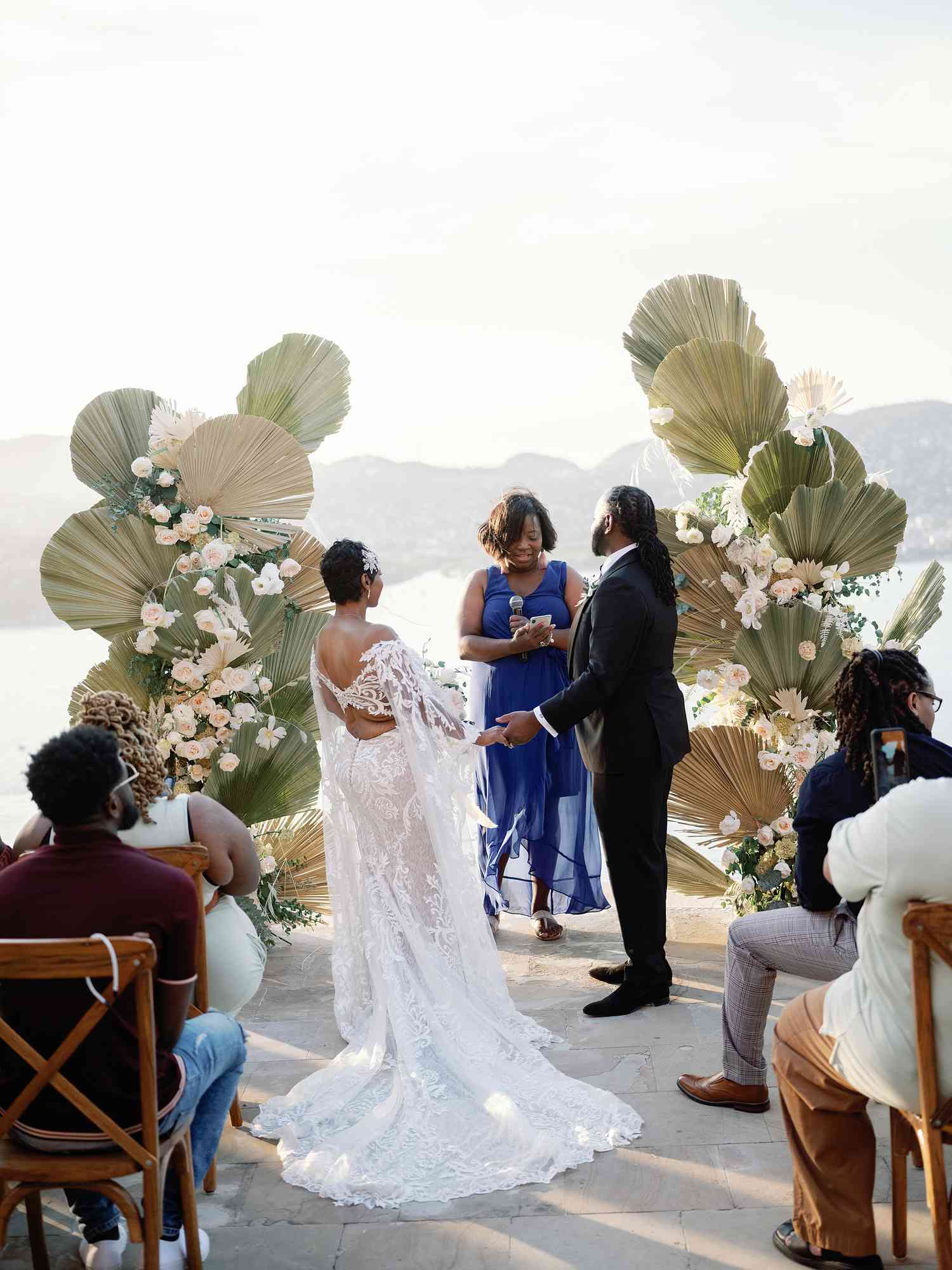Bride and Groom in Wedding Attire During Vow Renewal Overlooking the Ocean