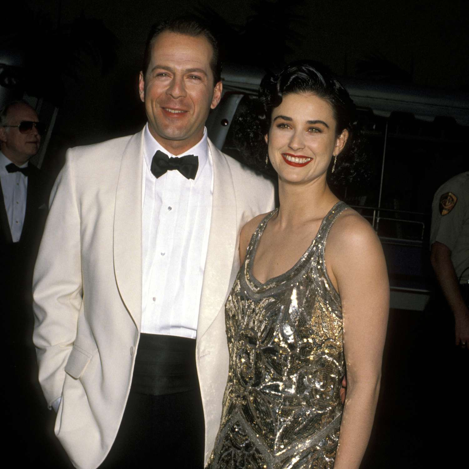 Bruce Willis in White Tuxedo and Demi Moore in Beaded Gown on Red Carpet
