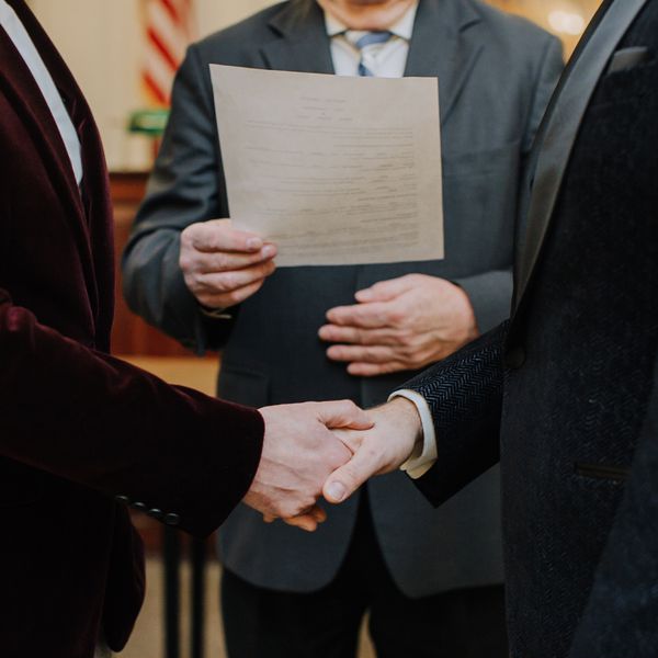 Groom's Holding Hands Getting Married in Courthouse Wedding