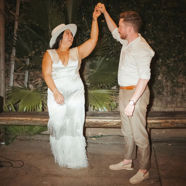 groom twirling a bride on the dance floor