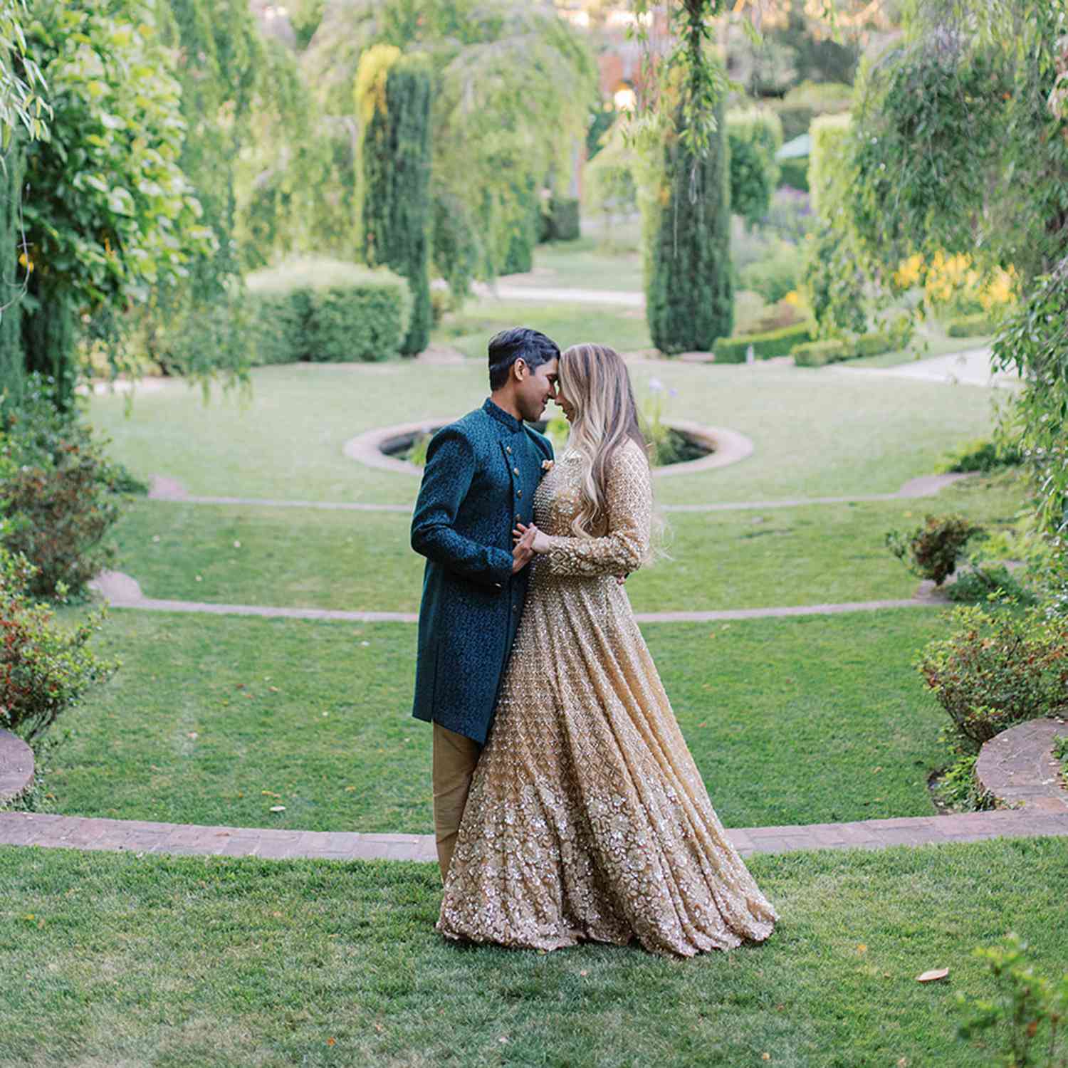 Bride and Groom in Traditional Indian Attire in Sunken Garden at Engagement Party Venue