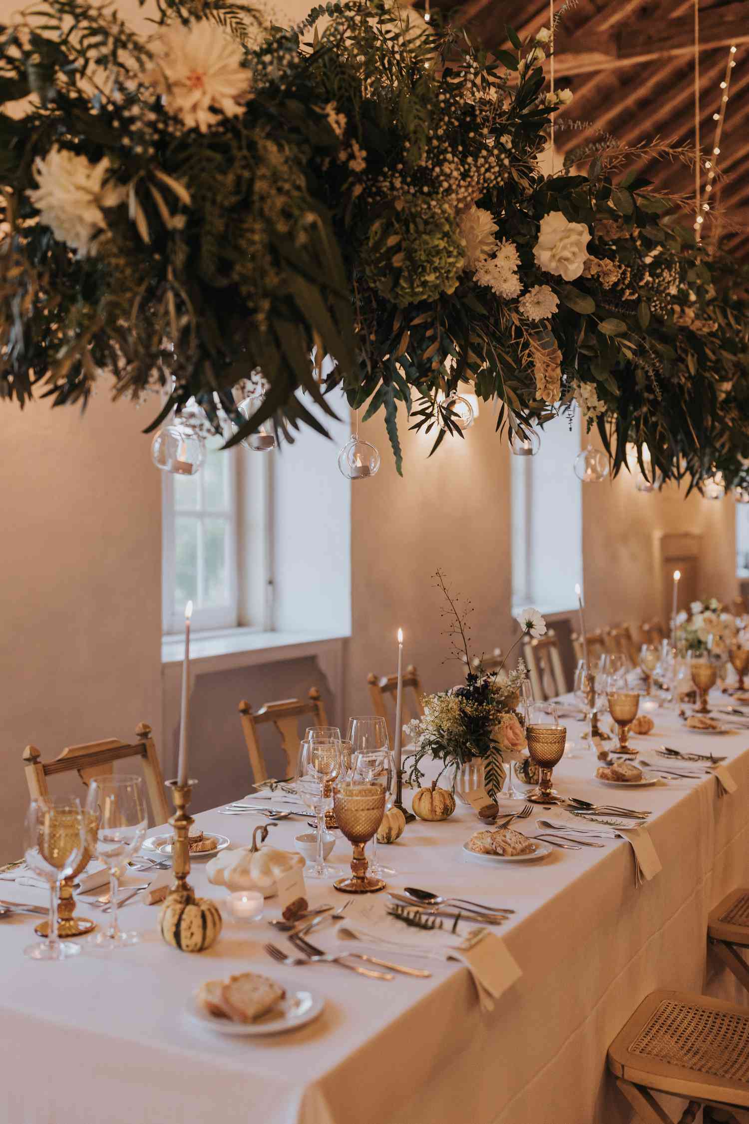 Long Wedding Reception Tables with Petite Floral Arrangements and Mini Pumpkins