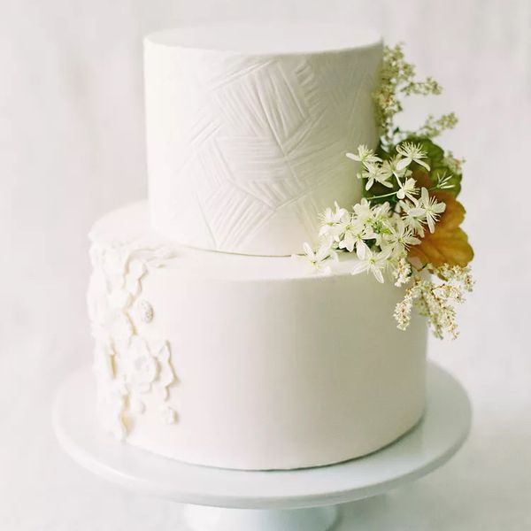 two tier white wedding cake with flowers