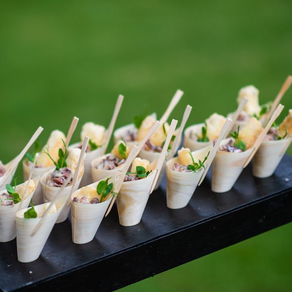 appetizers in cones being served during wedding's cocktail hour