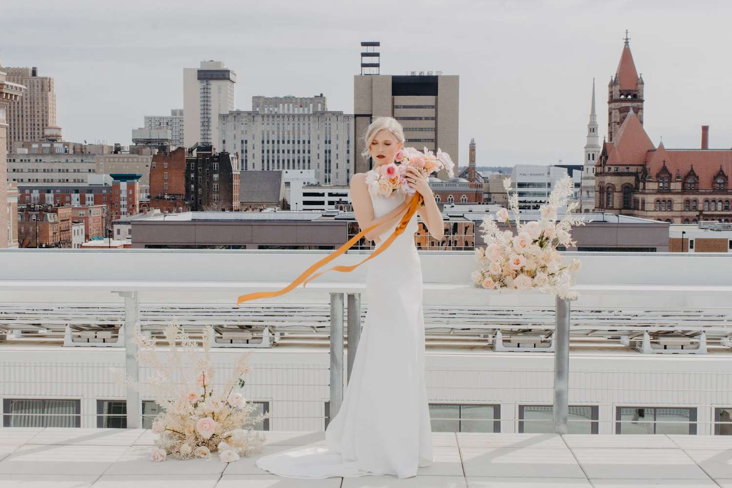 bride holding bouquet on rooftop