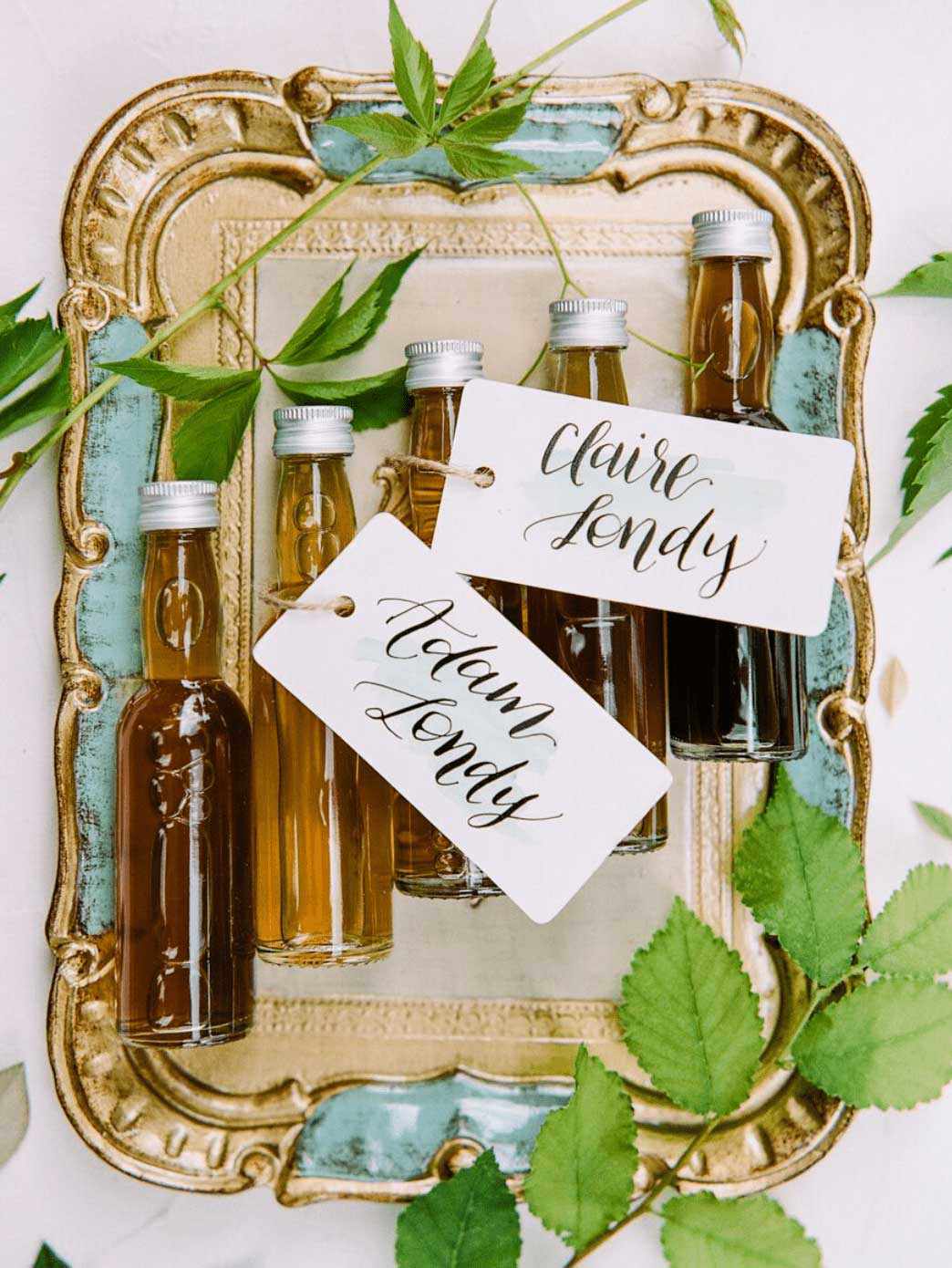DIY Favors of bottles of olive oil with guests names calligraphed on them