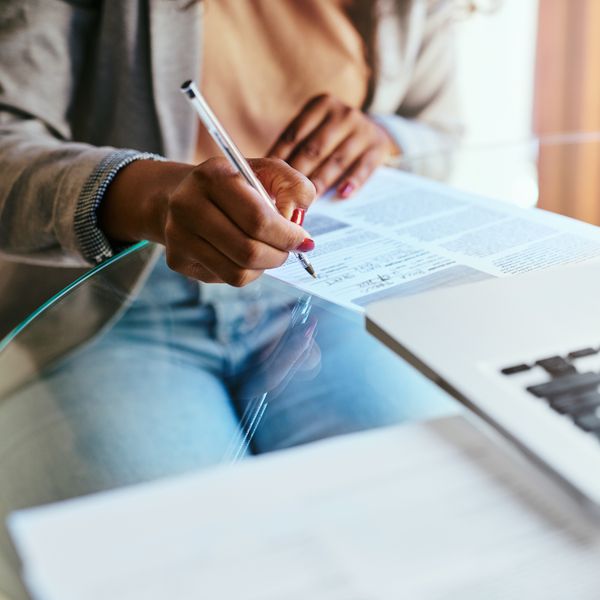 woman signing paper