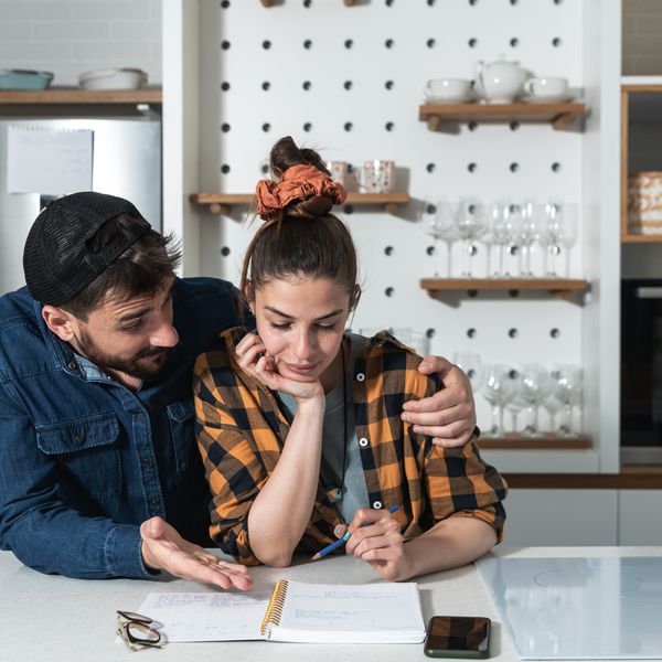 Couple standing in the kitchen making the wedding guest list