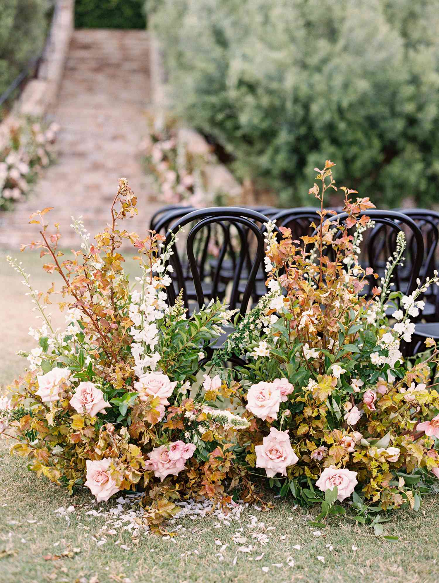 Ceremony florals with gold and red foliage and pink flowers