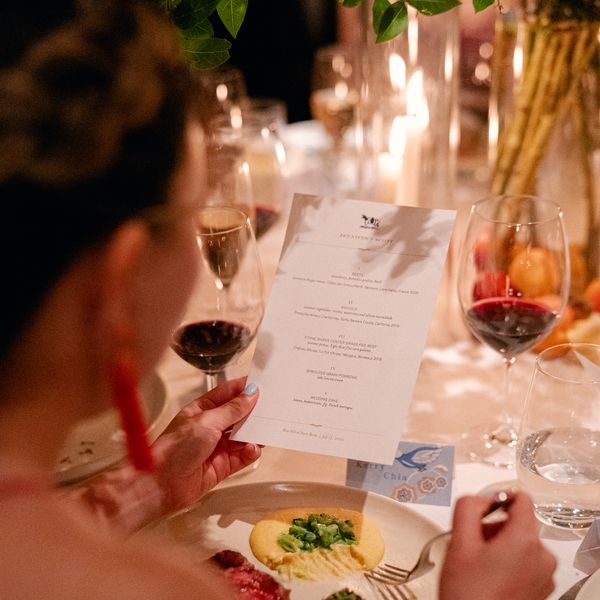 Guest reviewing wedding dinner menu at seated wedding reception