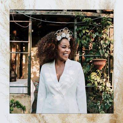 bride with bohemian wedding hairstyle and crown in suit