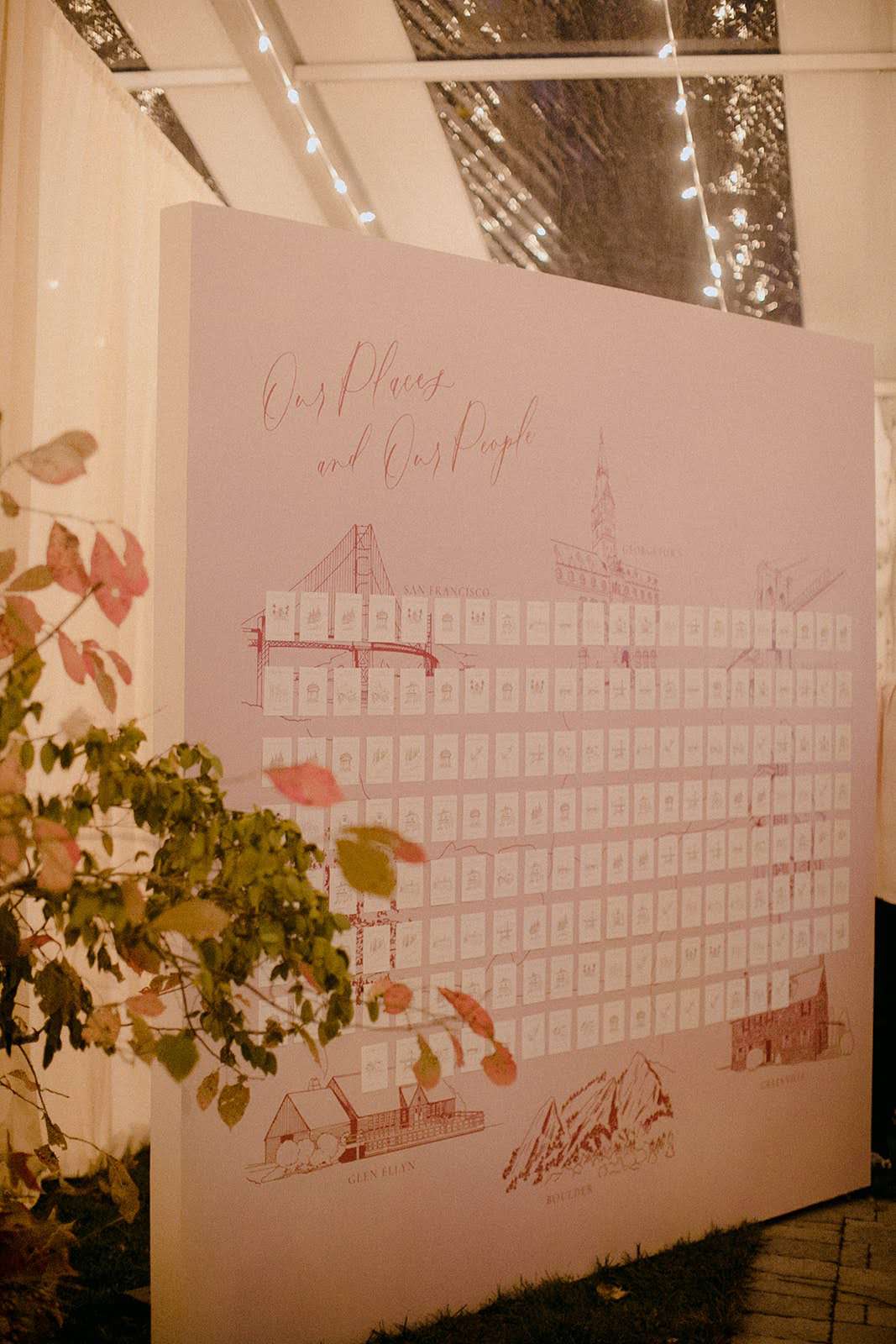custom escort board wall with hand-drawn illustrations of special places in the couple's life
