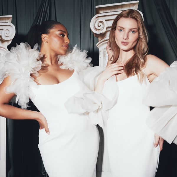 two models posing in wedding dresses together