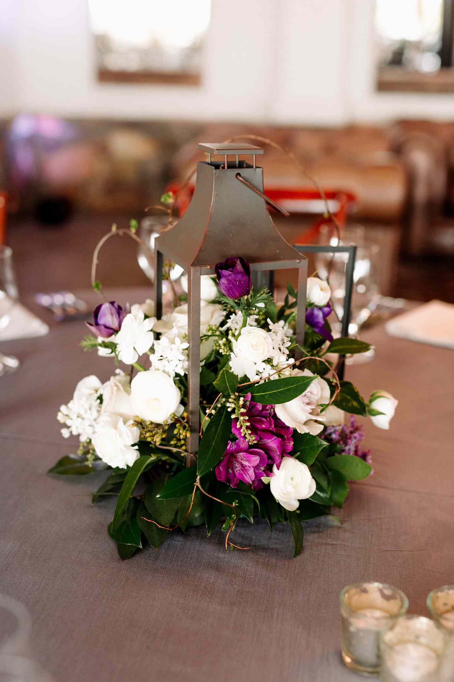 rustic lantern with white and purple flowers spilling out