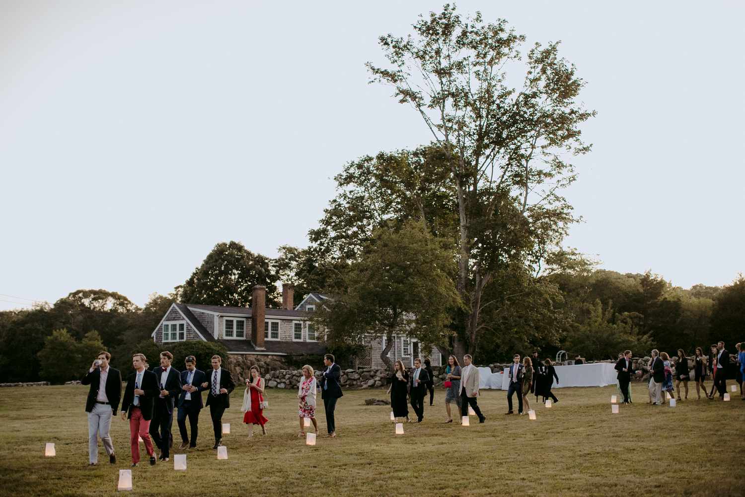 Guests Walking Along Lantern-Lit Path at Backyard Wedding