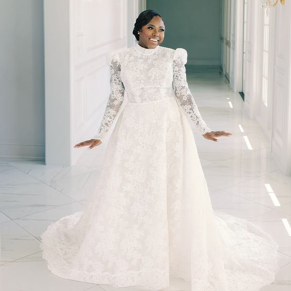 bride wearing a lace long-sleeve high-neck wedding dress