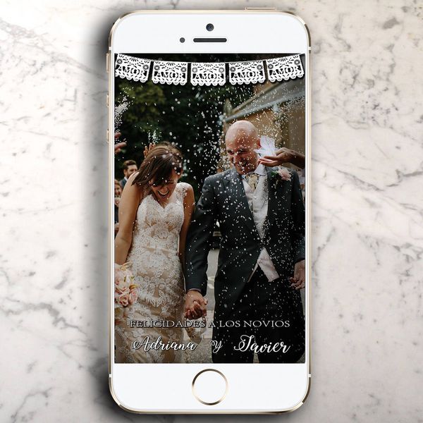 iPhone on a marble counter top with a wedding photo and geofilter in Snapchat