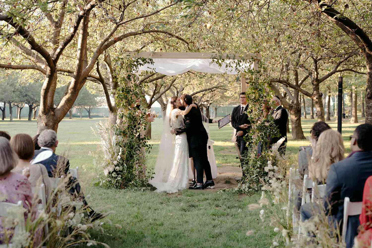 Newlyweds kissing under chuppah