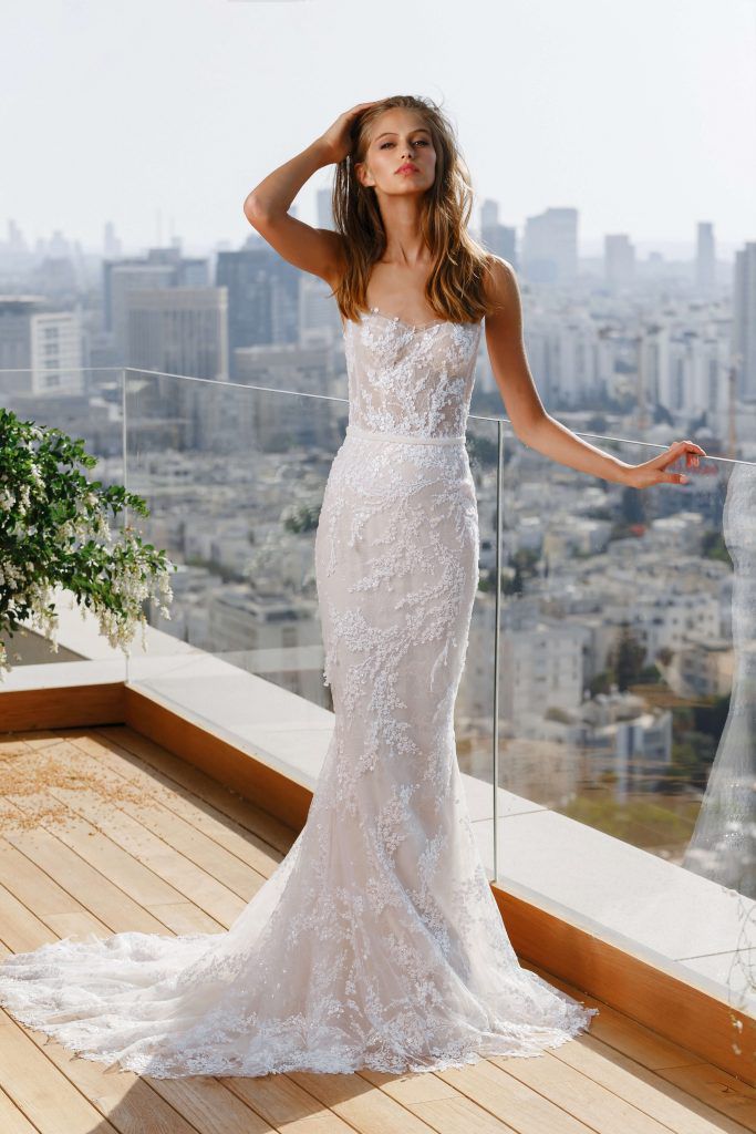 Model in strapless fitted lace gown