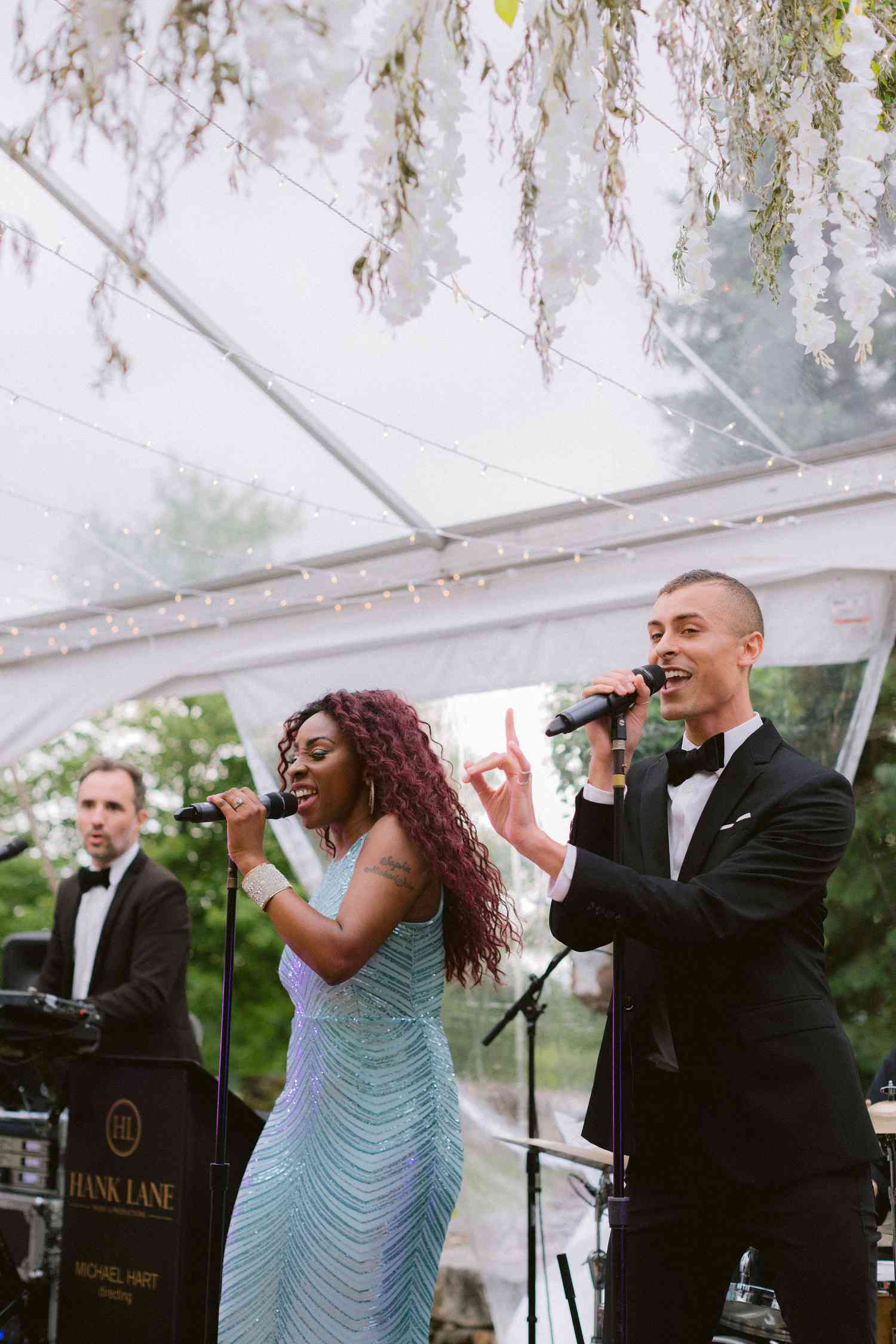 Live band performing at tented backyard wedding