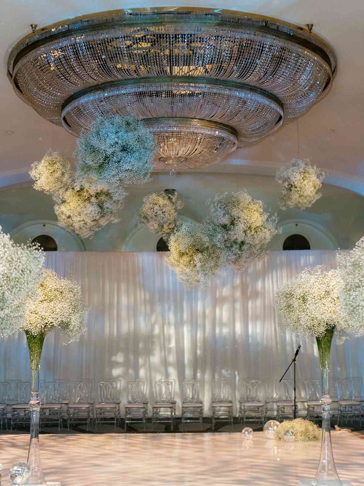 A chandelier focal point with clouds of white baby's breath