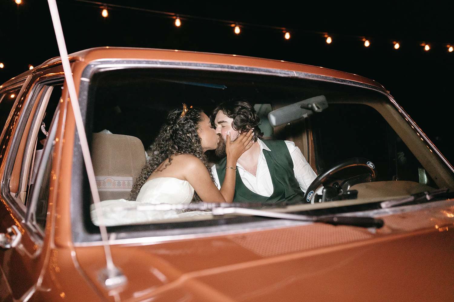 Justina and Jordan kissing in the car on their wedding night