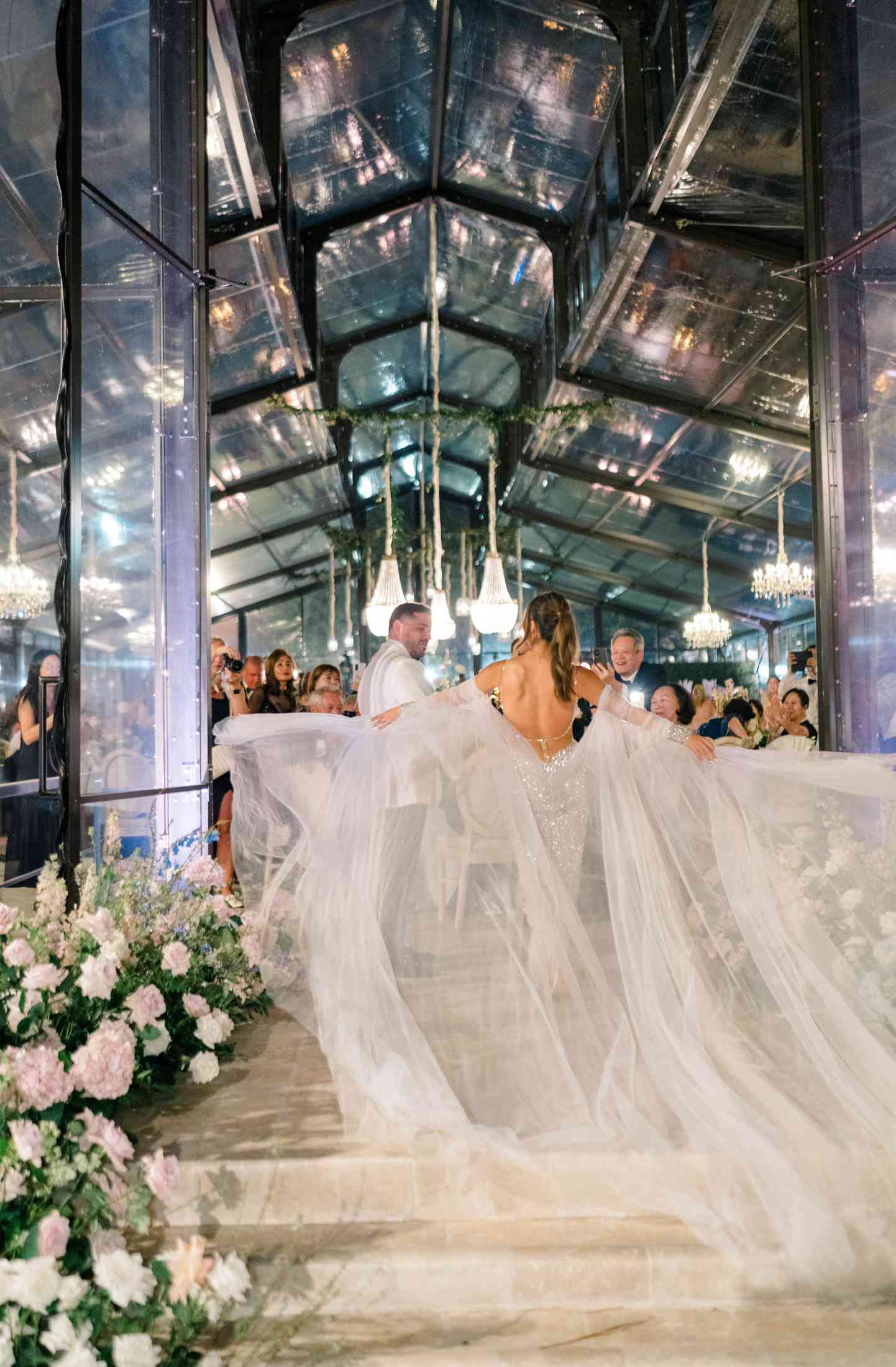 A Bride Spreads Her Dramatic Sleeves During Her Wedding Entrance