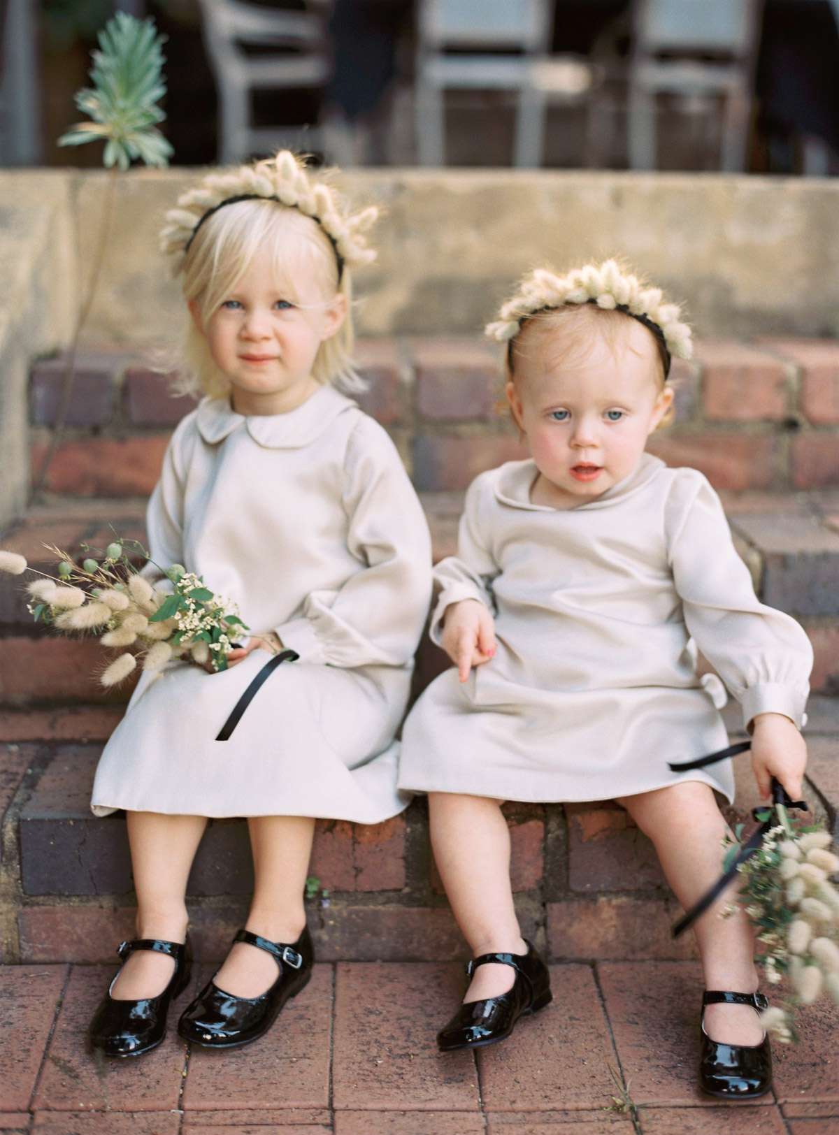 Flower girls with headbands and posies of dried bunny tails
