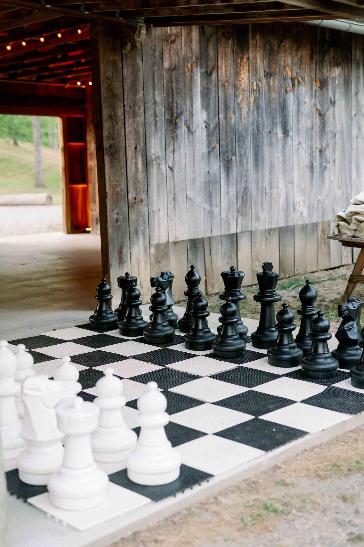 large chess set at backyard wedding